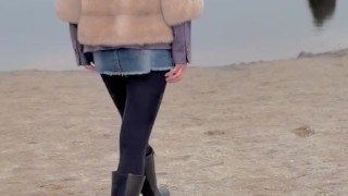 Walking along the beach without panties.